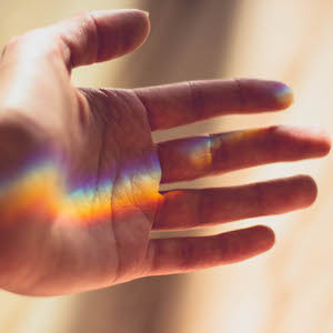 Healing touch, hand and rainbow