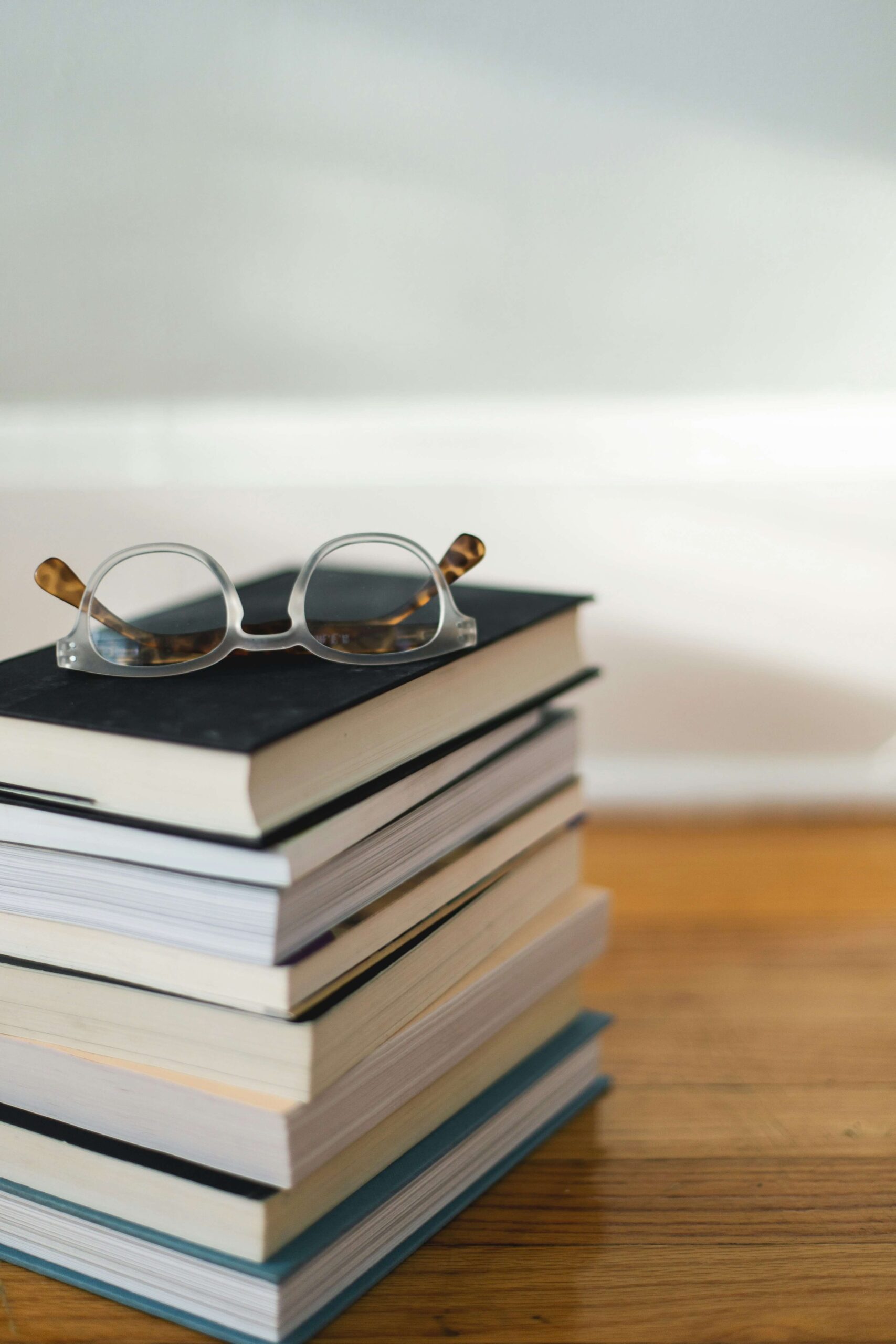 stack of books with glasses on top